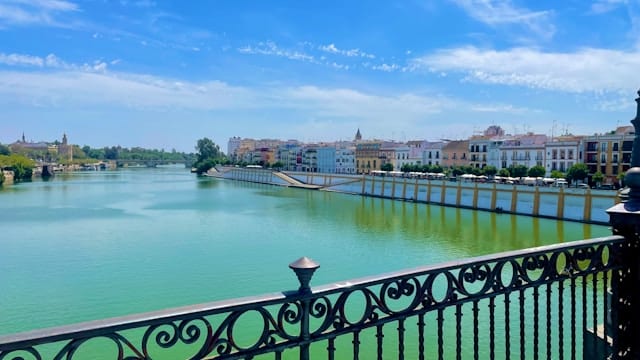 a view of a river with a bridge in the background