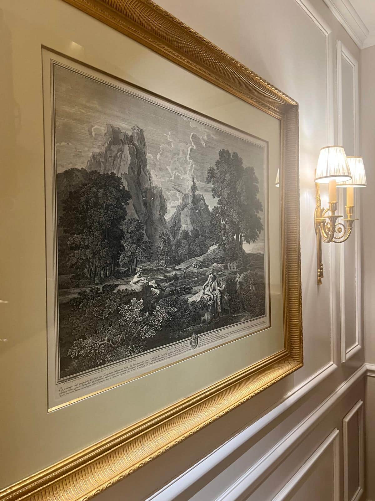 Vintage print in a gold framer on a luxury wall. Booking philosophy and companionship quality