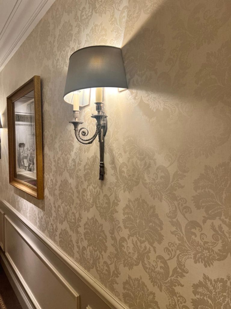 Luxury sconce and damask wallpaper - rebuilding connections after divorce.